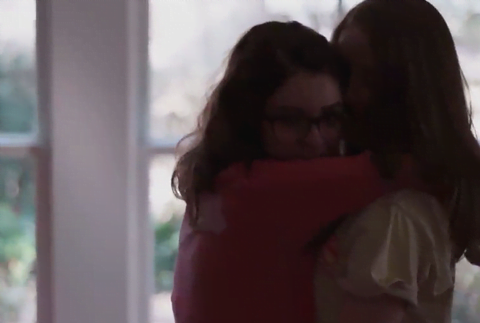 Two girls hug