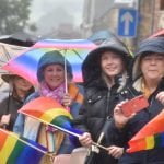 Crowds wait for the parade in the rain, 2023